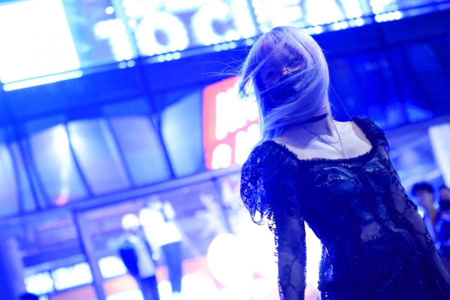 A Masked Woman Dances on a Public Square in Beijing