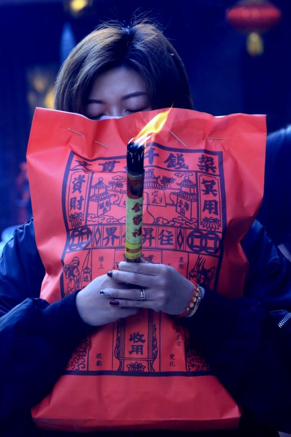 Masked Templegoer Holding Tight Onto Her Incense Bag