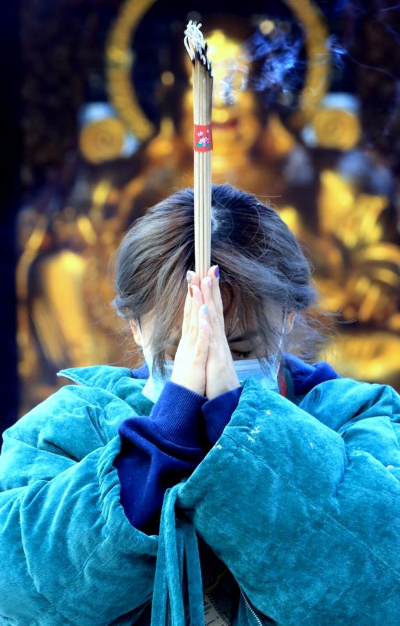 A Masked Woman's Incense Prayer Got Buddha's Backing