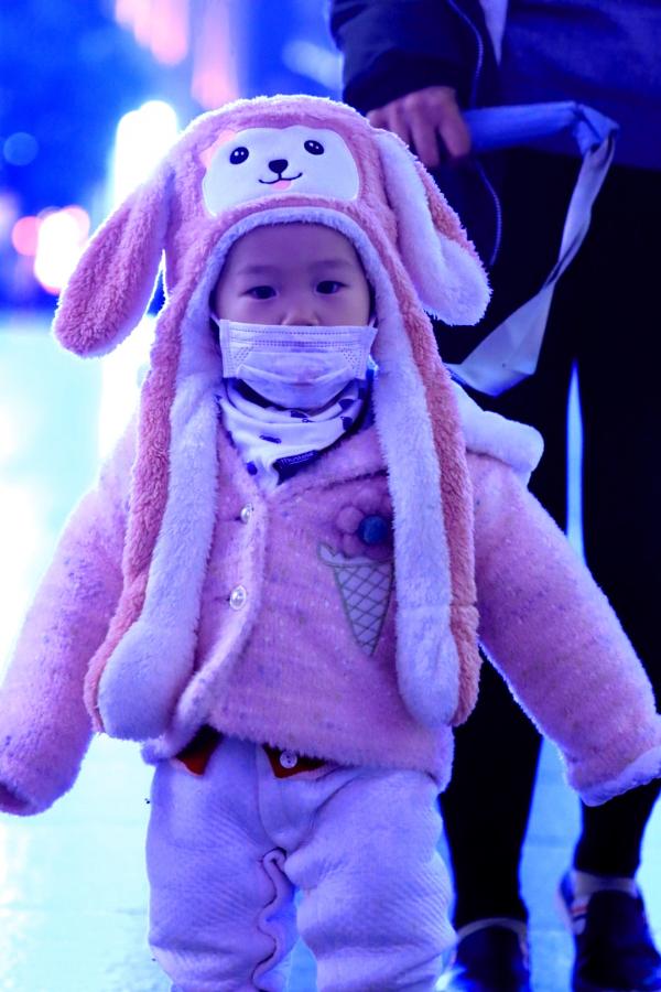 A Masked Toddler is Steered Remotely in Shanghai