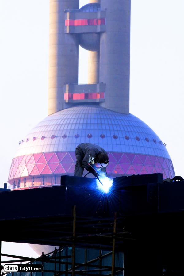 Welding in front of Oriental Pearl Tower