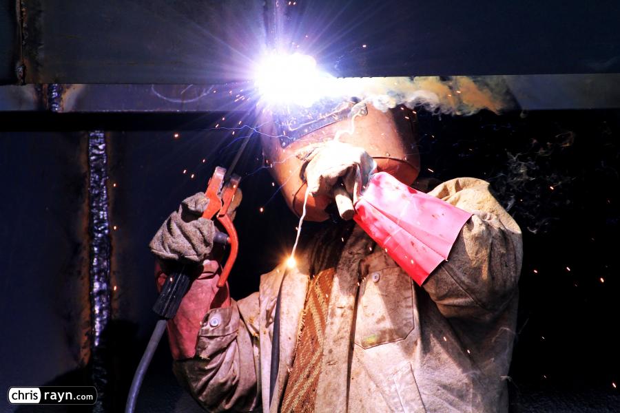 Construction worker welding a steel frame 