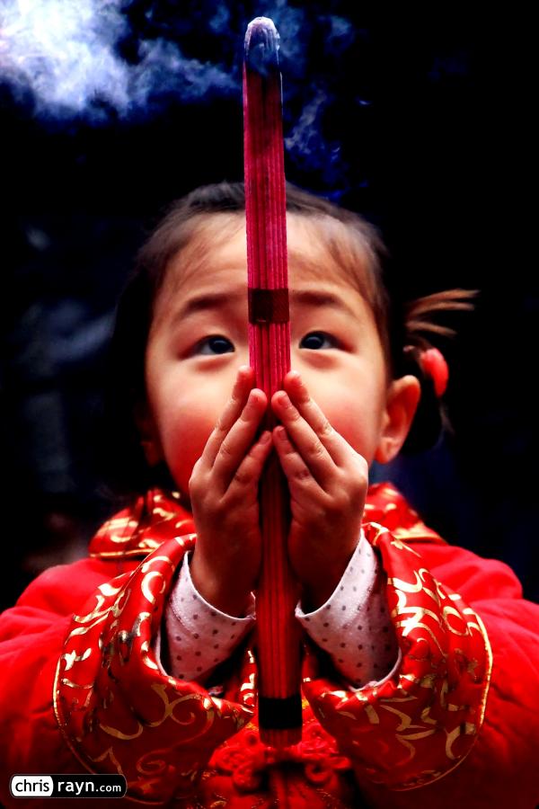 A Chinese praying girl, looking up to her future