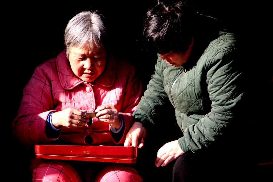 Shanghai Grannies Looking At Old Photos in Laoximen