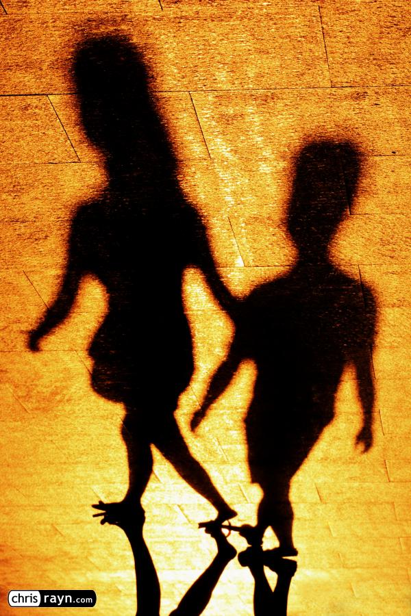 Shadows of a couple, woman leading