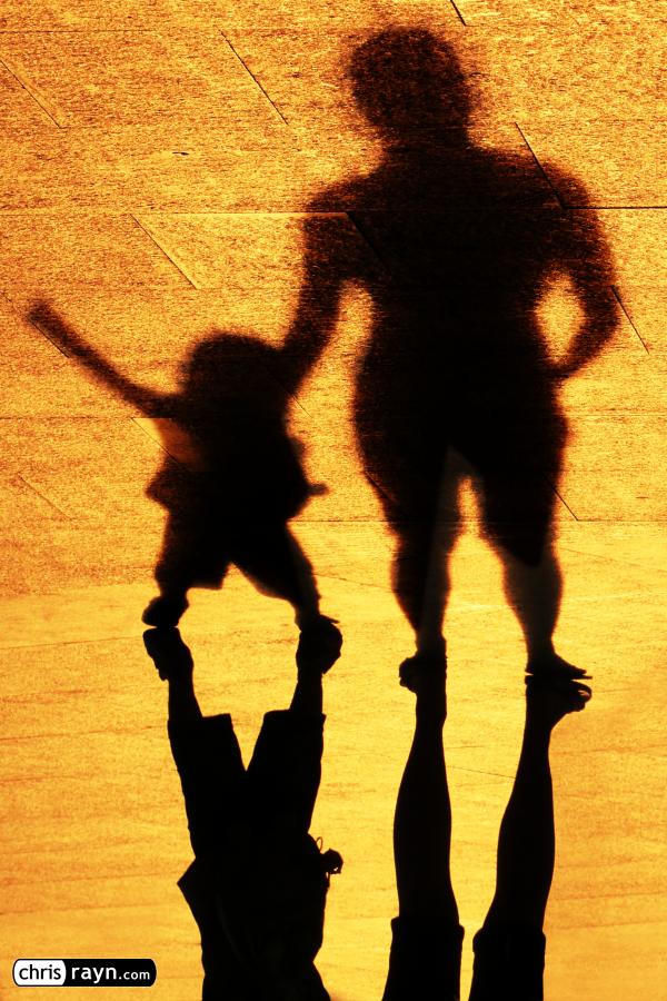 In shadows, toddler throws temper tantrum with his father