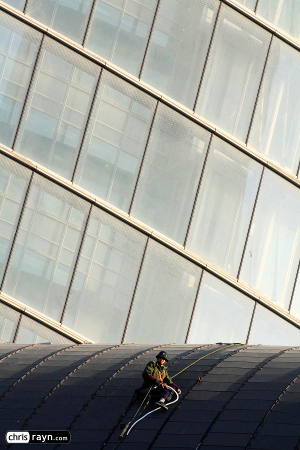 A worker stranded in front of Shanghai Tower's curtain wall